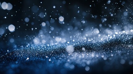 Scattered gradient silver to navy particles against a dark backdrop create a sleek, sophisticated design element