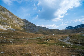 Mountain valley with scattered rocks under cloudy sky. Durmitor National Park. Montenegro