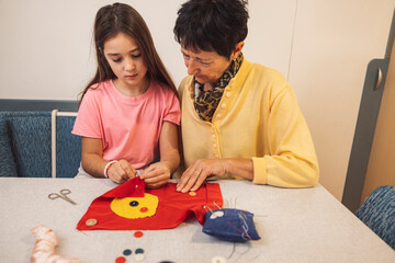 Crafting Together: A Young Girl and Elderly Woman