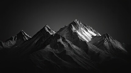 High contrast black and white image of rugged mountain range with dramatic shadows and highlights on a solid black background