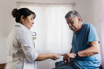 An older adult at a medical checkup in a young nurse's office.