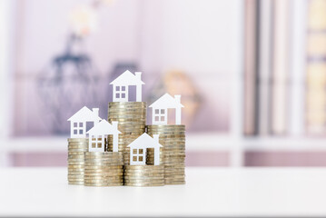 Mortgage loan or home equity loan, financial concept : Tiny model residential house perched atop...
