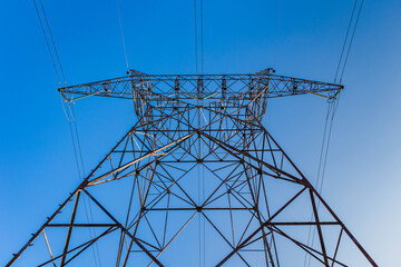 Pedestals of a high-voltage pylon in countyside. High voltage electric power grid.