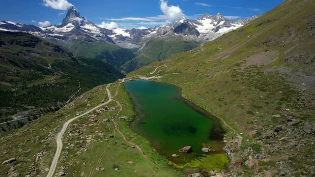  famous hiking routes in Switzerland , Valais canton - five most beautiful mountain lakes in Zermatt. aerial drone 4k hd video of Stellisee lake and Matterhorn iconic mountain