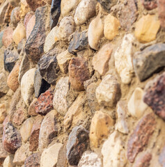Concept shot of the rough wall made of stones. Surface