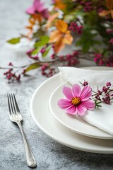 Elegant tabletop setting with fresh flowers and a silver fork in a natural light arrangement