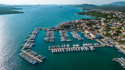 An aerial view of Pirovac Marina in Croatia, showcasing a stunning collection of yachts docked...