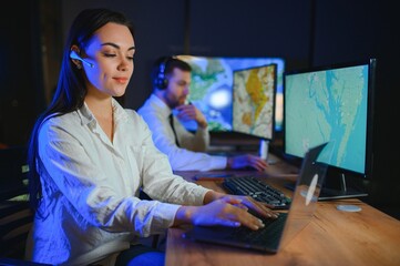 Center of dispatching maintenance. Portrait of cheerful woman and man working via headset...