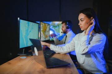 Center of dispatching maintenance. Portrait of cheerful woman and man working via headset...