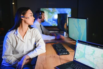 Center of dispatching maintenance. Portrait of cheerful woman and man working via headset...