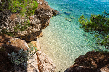 Landscape photo of rocky adriatic shore and crystal clear water. Brela, Dalmatia, Croatia. Adriatic sea.