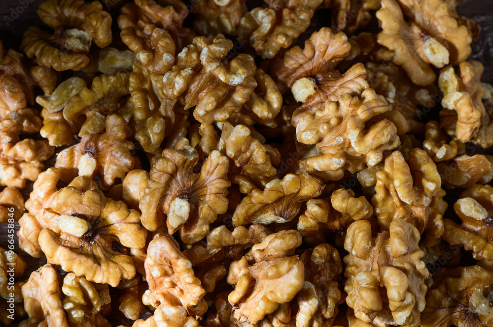 Wall mural many tasty walnuts as background, top view