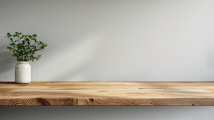 Kitchen wooden countertop on white wall background. Minimalistic room with tabletop and plant in vase for product presentation. Clean closeup mockup.