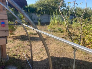 Fototapeta premium Installation of a metal frame greenhouse with polycarbonate covering