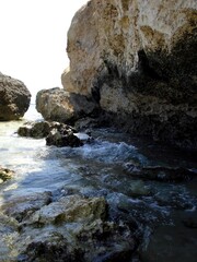 Rocky Desert Shore Along the Red Sea With Gentle Waves and Sunlit Cliffs in the Background