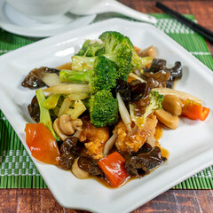 salty chijaukay with vegetables and chicken meat, served with chaufa rice, siu mai and wuantan soup. chifa, peruvian food