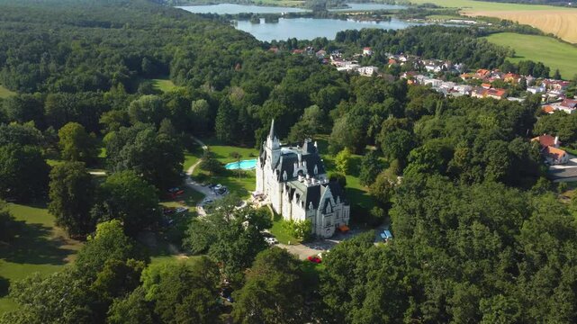 Stunning 4K drone footage of Budmerice Castle in Slovakia. Discover breathtaking aerial views of this picturesque 19th-century castle surrounded by lush greenery and beautiful gardens