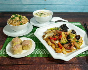 pork meat with vegetables, served with chaufa rice, wuantan soup and siu mai, chifa, peruvian food