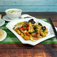pork meat with vegetables, served with chaufa rice, wuantan soup and siu mai, chifa, peruvian food