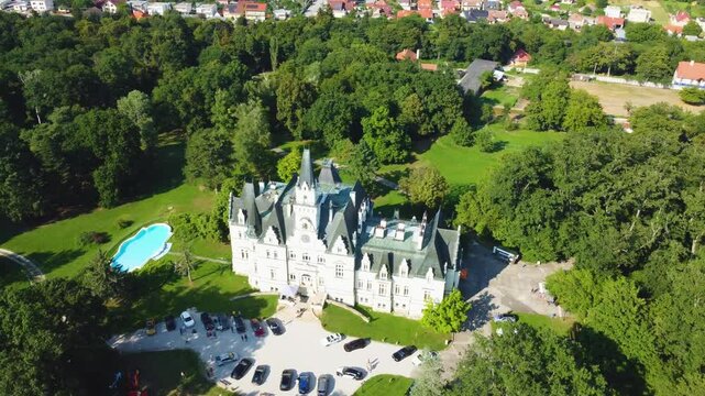 Stunning 4K drone footage of Budmerice Castle in Slovakia. Discover breathtaking aerial views of this picturesque 19th-century castle surrounded by lush greenery and beautiful gardens