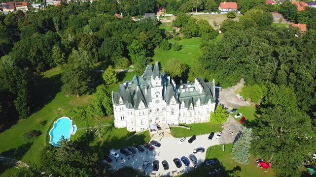 Stunning 4K drone footage of Budmerice Castle in Slovakia. Discover breathtaking aerial views of this picturesque 19th-century castle surrounded by lush greenery and beautiful gardens
