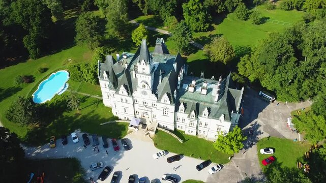Stunning 4K drone footage of Budmerice Castle in Slovakia. Discover breathtaking aerial views of this picturesque 19th-century castle surrounded by lush greenery and beautiful gardens