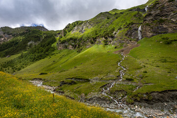 Mountain landscape with waterfall in Alps