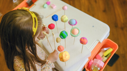 Solar system model toy planets made by kid from colorful molding clay on beige background with blank space for text. DIY activity for children concept. © Денис Максимчук