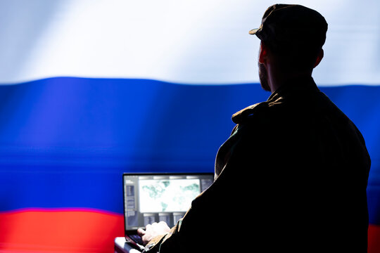 Kremlin regime russian agent combating organized crime and terrorism using detection system on laptop. Russia FSB officer protecting national sovereignty by tracking terrorists