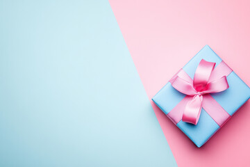 Gift box with pink ribbon on pastel blue and pink background.