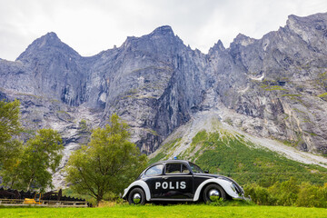 Old police car in front of the Trollveggen, Norway © Simon van Hemert