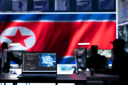 Military personnel working in a command post with a North Korea flag on big screen, monitoring activity via gps and world map. Soldiers developing warfare tactics for scams.
