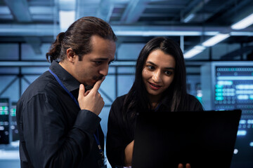IT experts in server hub doing brainstorming, finding ways to ensure data remains shielded from...