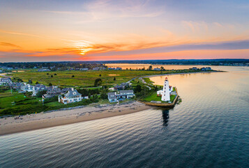 Summer sunset on the Connecticut River, Shoreline, and Long Island Sound in Old Saybrook, CT, with Lynde Lighthouse in the foreground, along with Fenwick, and a colorful summer sunset sky © Greg Boivin