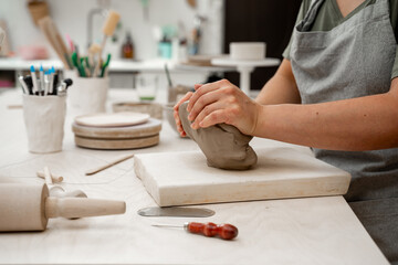 Removing air bubbles from clay before modeling to avoid the ruination of a ceramic product. Wedging...