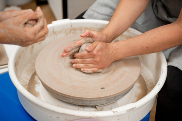 Ceramics workshop. Learning how to create a bowl using a pottery wheel. Modeling a shape of your...