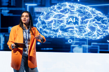 Computer scientist holding presentation at AI tech summit event gathering professionals using...