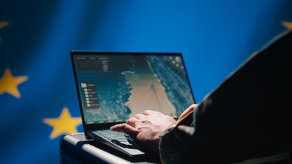 European Union using radar system on laptop to detect incoming ballistic missiles attacking member states. EU alliance army soldier scanning rockets approaching countries, deploying shields, camera B
