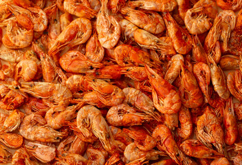 Shrimp close-up in a large pile. Smoked and salted shrimp with spices for a beer snack.