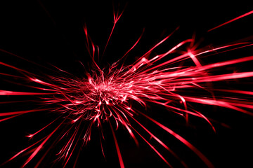 red  sparks from the grinder glowing in the dark