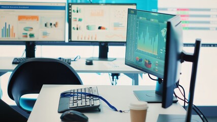 Empty telecommunications control room with workstations, coworking space equipped with a big screen and modern devices used in organizational daily tasks and projects. Camera A.