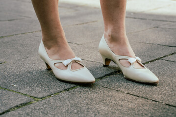 White women's elegant retro shoes on girl's feet