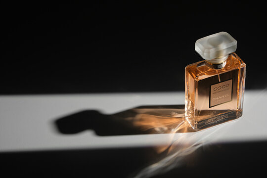 Lviv, Ukraine-September 14, 2023. Chanel Coco Mademoiselle perfume bottle on a black background with beautiful shadows and light reflections. Perfume advertising concept.