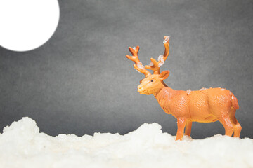 Plastic reindeer in a Moonlit Artificial Snowy Landscape, Miniature Minimalist Winter Scene