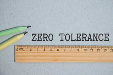 ZERO TOLERANCE. text on white paper on gray background