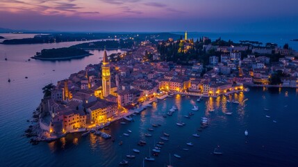 Fototapeta premium aerial view of a beautiful coastal town with a church tower on a sunset night