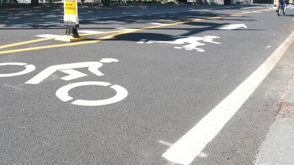 Bike lane asphalt sign, New York City. Bicycle path, cycle route for bicyclists, Manhattan. Way for roller skating and skates. Recreational sport activity infrastructure, biker cycling, United States.