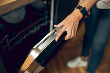 Woman in the kitchen dealing with dishwashing