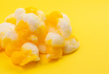 Freeze Dried Lemon Flavored Candy on a Bright Yellow Background