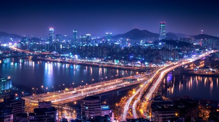 Obraz premium A stunning night view of a city with bright lights, modern buildings, and a bustling bridge crossing over a calm river.